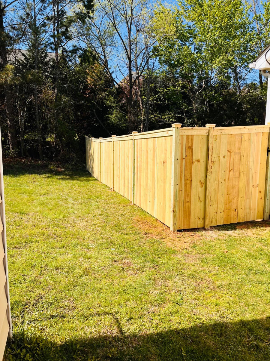 Pressure treated wood privacy fence
