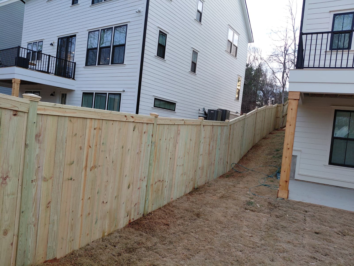 Pressure treated pine wood privacy fence.